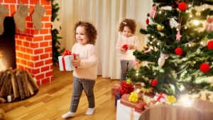 Children with gifts at Christmas, New Year's in the room with th